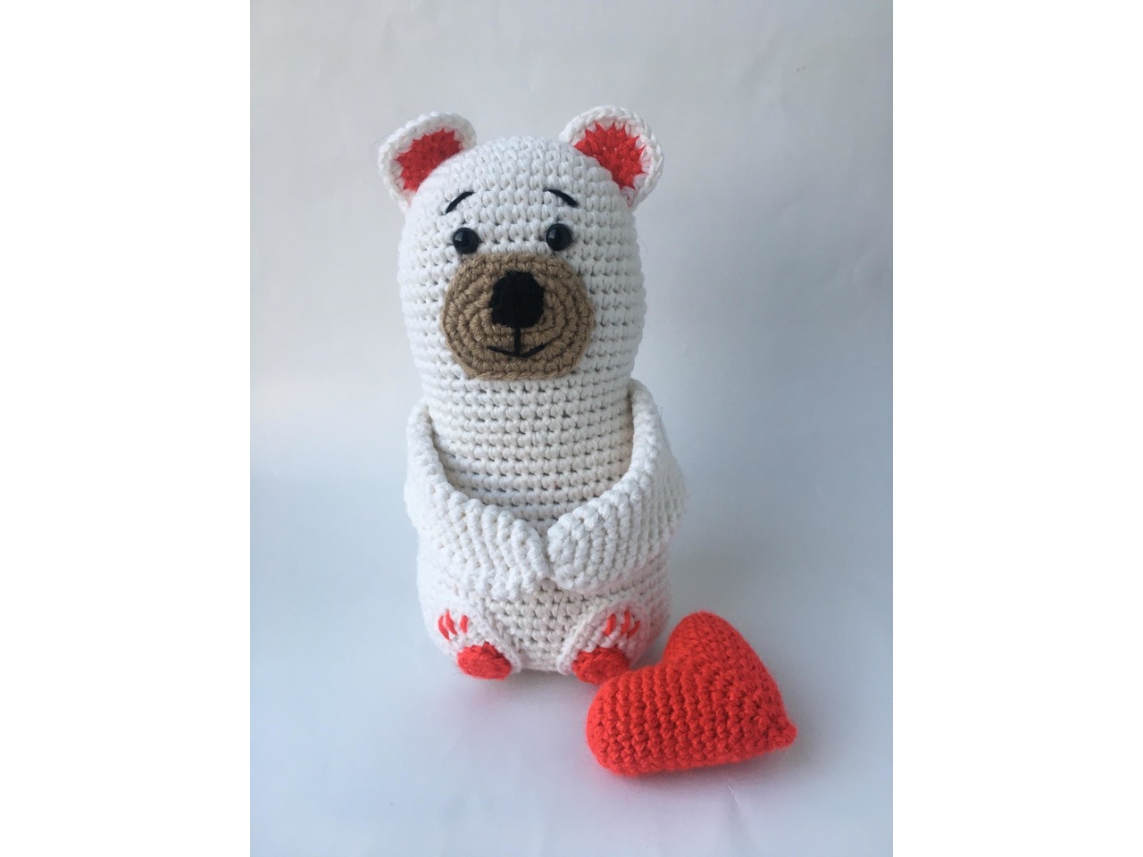Crochet teddy bear in a dress with a bow
